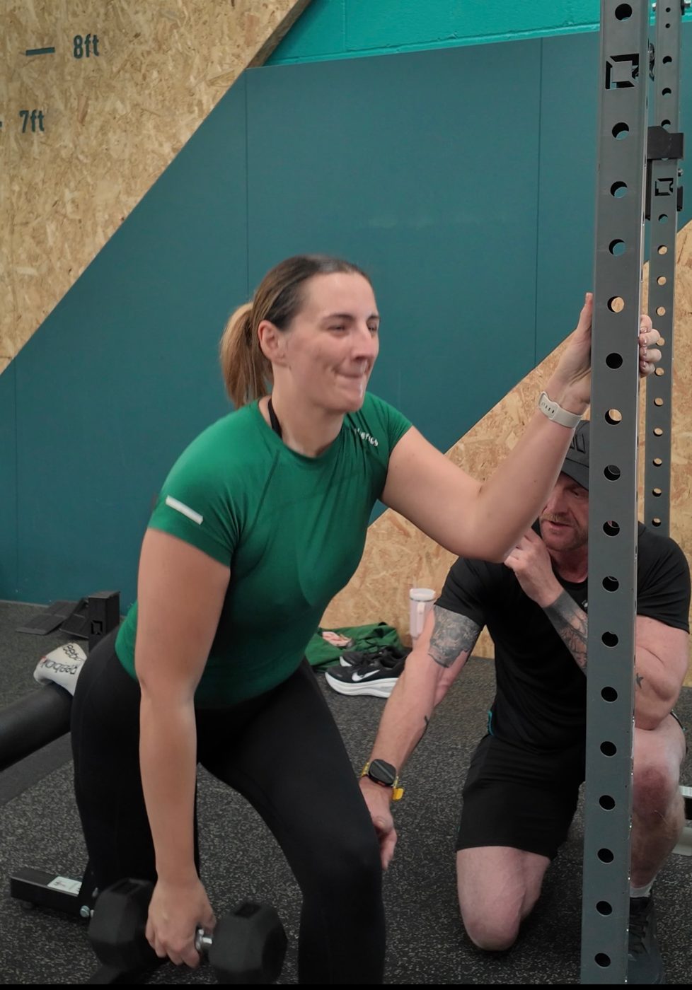 Julian coaching a split squat at the rack